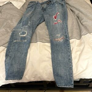 Distressed repaired denim jeans.